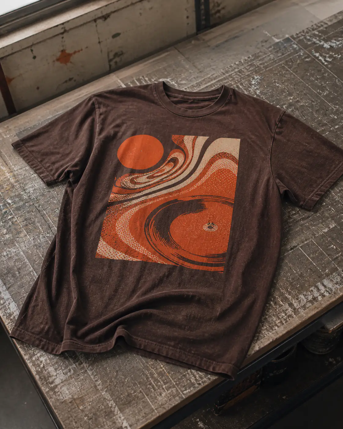 Washed brown T-shirt with a distressed two-color music graphic