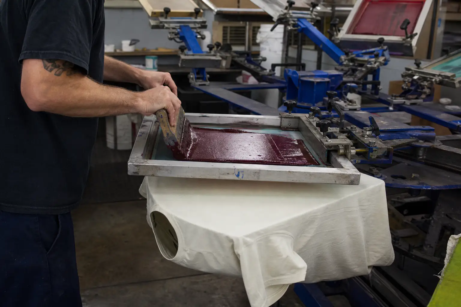 Printer pulling ink across a screen on a manual press